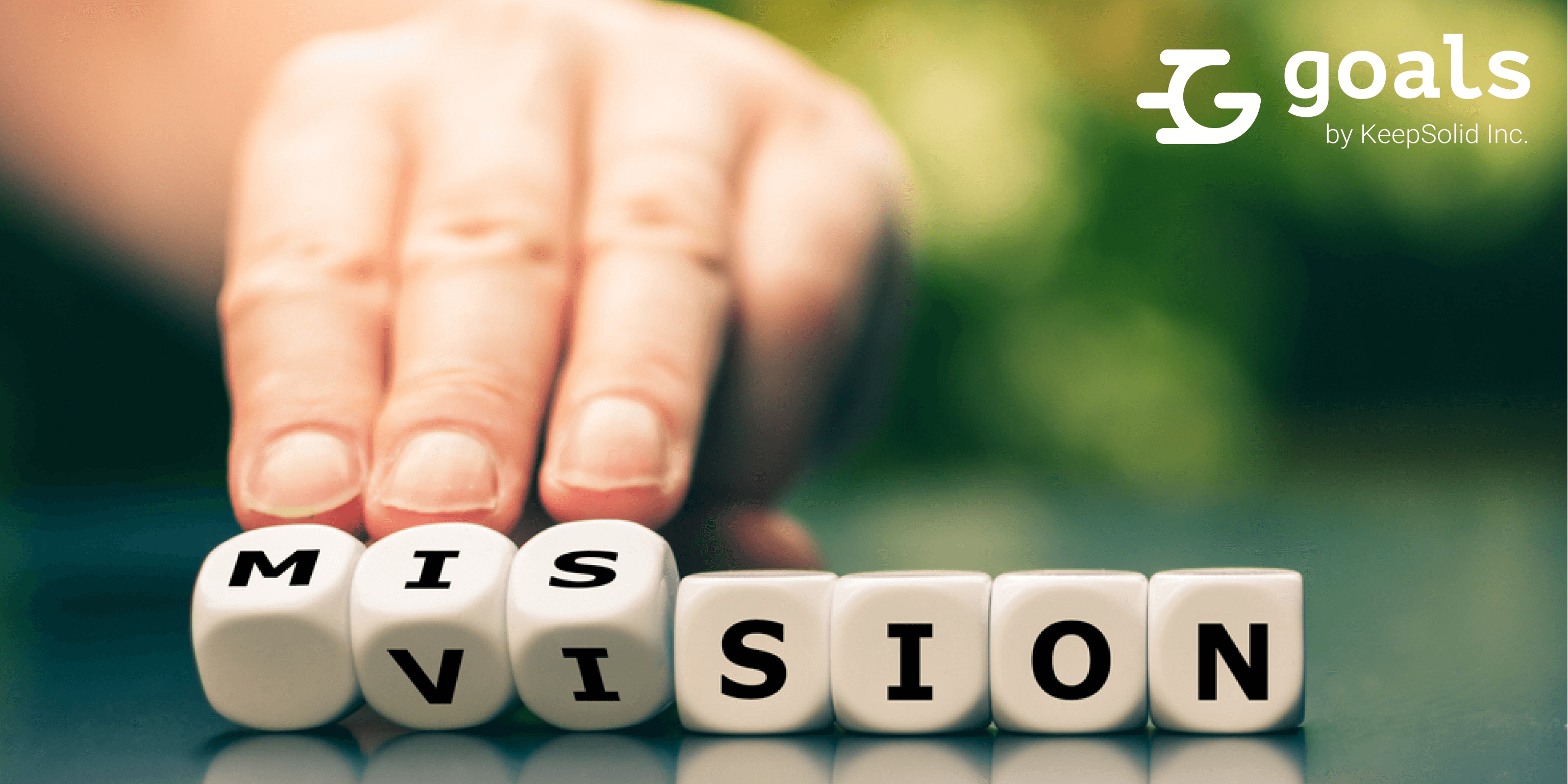 From a vision to a mission. Hand turns dice and changes the word vision to mission